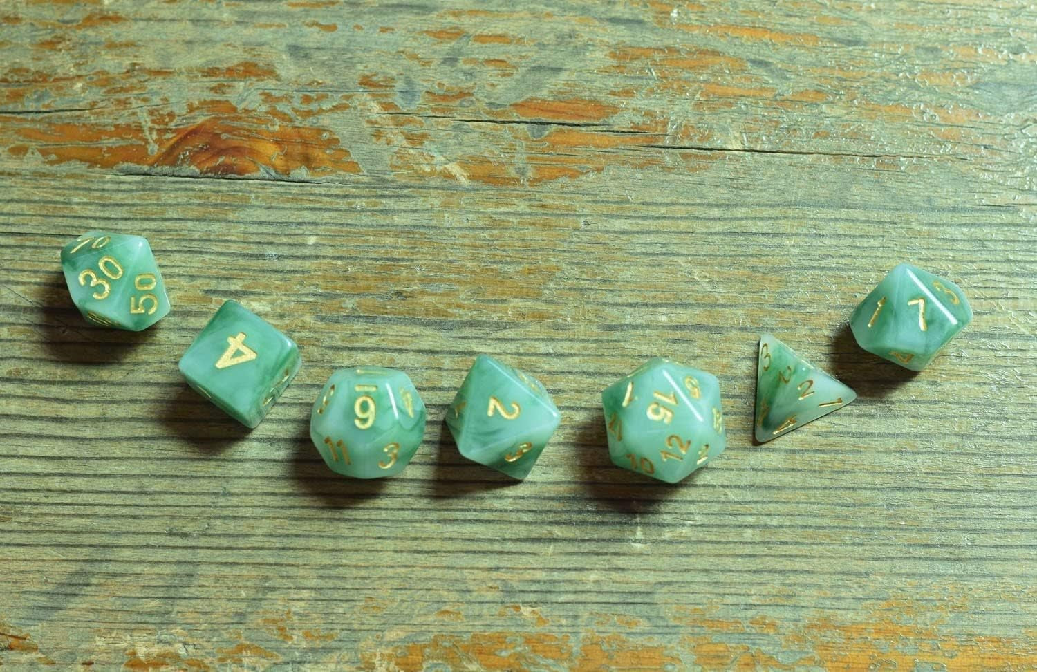 Jade green resin polyhedral D&D dice set with gold numbering