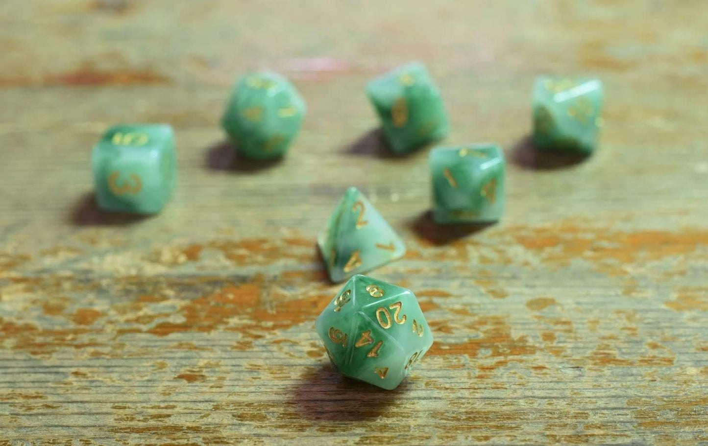 Jade green resin polyhedral D&D dice set with gold numbering